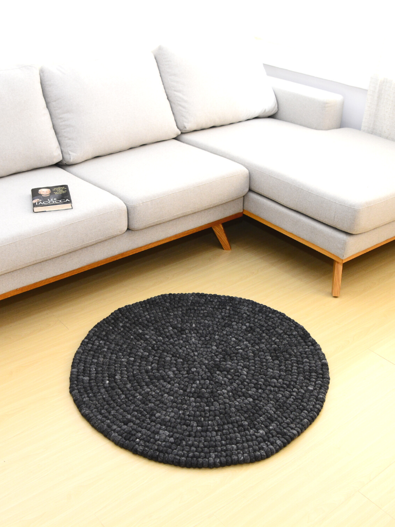 round wool felt ball rug on charcoal grey
