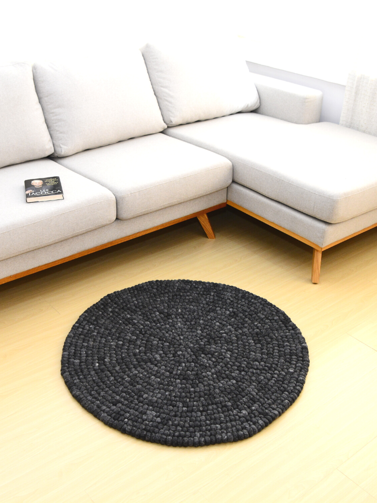 round felt ball rug on charcoal grey