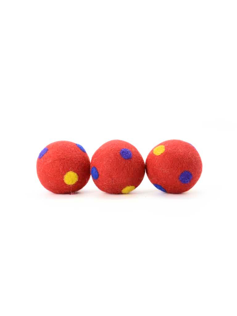 Hand-felted red wool balls dotted with colorful polka dots, perfect for garlands, wreaths, or playful accents.